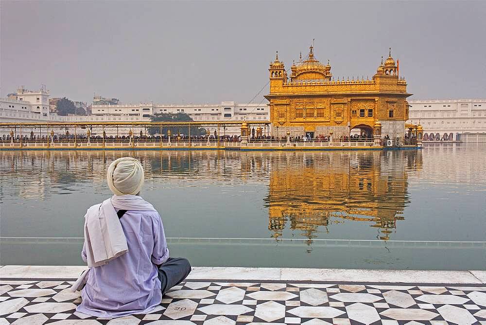 pilgrim and sacred pool Amrit Sarovar, Golden temple, Amritsar, Punjab, India