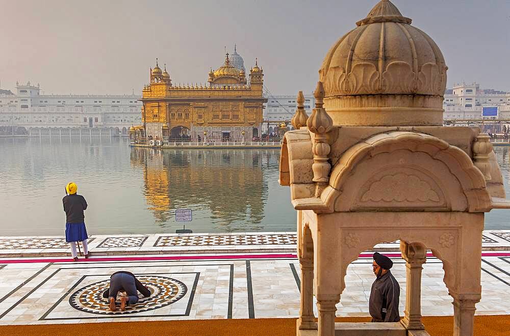 pilgrims and sacred pool Amrit Sarovar, Golden temple, Amritsar, Punjab, India