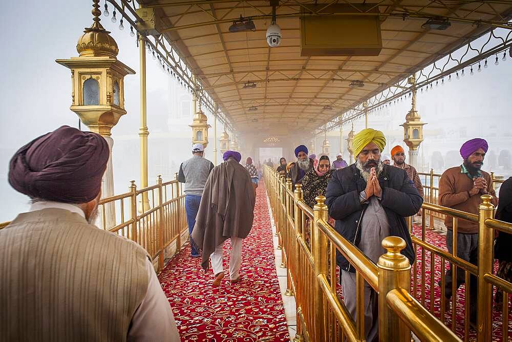 Devotees at causeway to Golden temple, Amritsar, Punjab, India