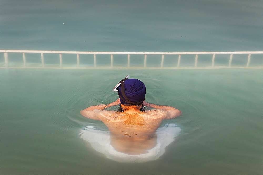 pilgrim bathing in the sacred pool Amrit Sarovar, Golden temple, Amritsar, Punjab, India