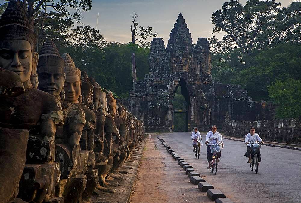 Woman, women, biking, Bridge and South Gate of Angkor Thom, Angkor, Siem Reap, Cambodia