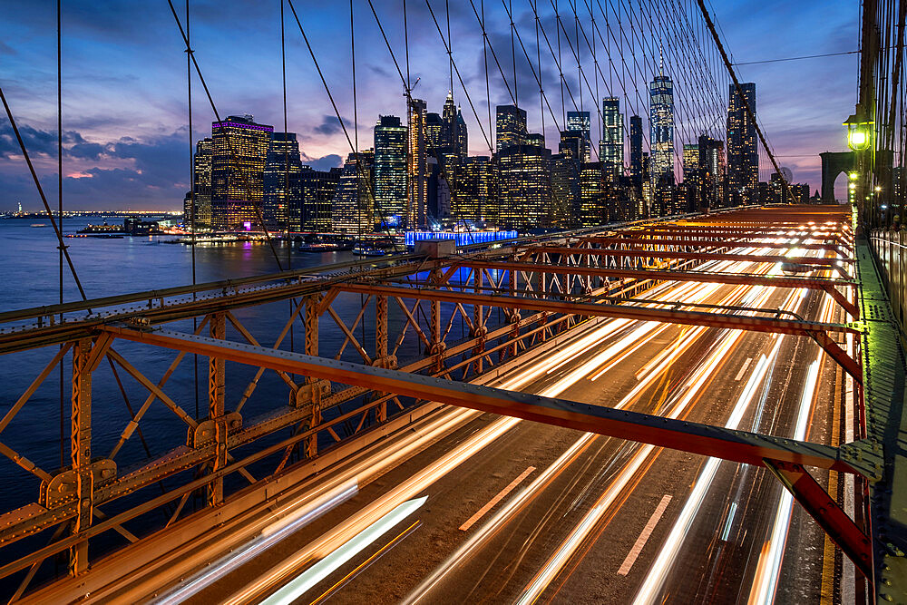 Traffic crossing the Brooklyn Bridge and the Manhattan skyline at night, Manhattan, New York, United States of America, North America