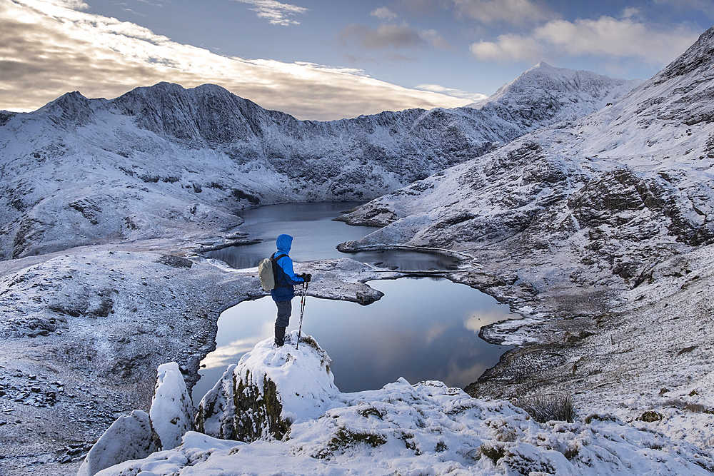 Walker looking out over Mount Snowdon (Yr Wyddfa), Y Lliwedd and Llyn Llydaw in winter, Snowdon Horseshoe, Cwm Dyli, Eryri, Snowdonia National Park, North Wales, United Kingdom, Europe