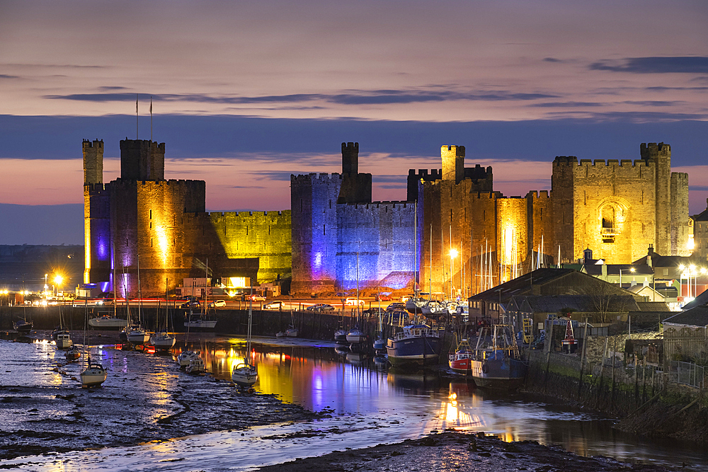 Caernarfon Castle, UNESCO World Heritage Site, and the Seiont Estuary at night, Caernarfon, Gwynedd, North Wales, United Kingdom, Europe