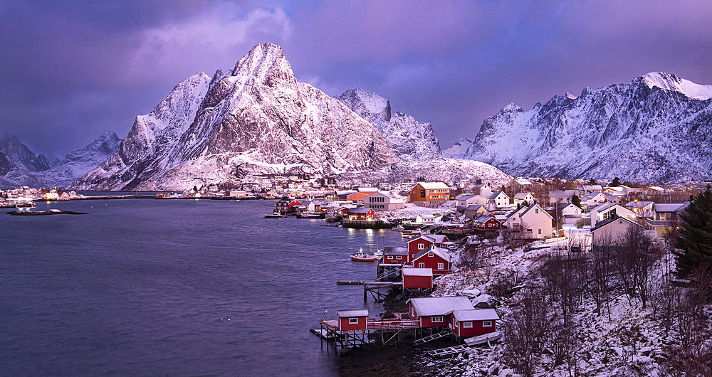 The fishing village of Reine and Olstinden mountain at dawn in winter, Moskenes Municipality, Nordland County, Lofoten Islands, Norway, Scandinavia, Europe