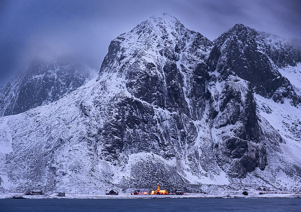 Flakstad Church (Flakstad Kirke) and Flakstadtind Mountain across Flakstadpollen Fjord at night in winter, Flakstad Municipality, Nordland County, Lofoten Islands, Norway, Scandinavia, Europe