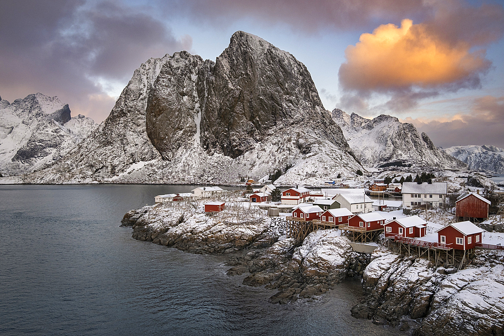 Red Norwegian Rorbuer Huts and Festhaeltinden mountain in winter, Hamnoy, Moskenes Municipality, Nordland County, Lofoten Islands, Norway, Scandinavia, Europe