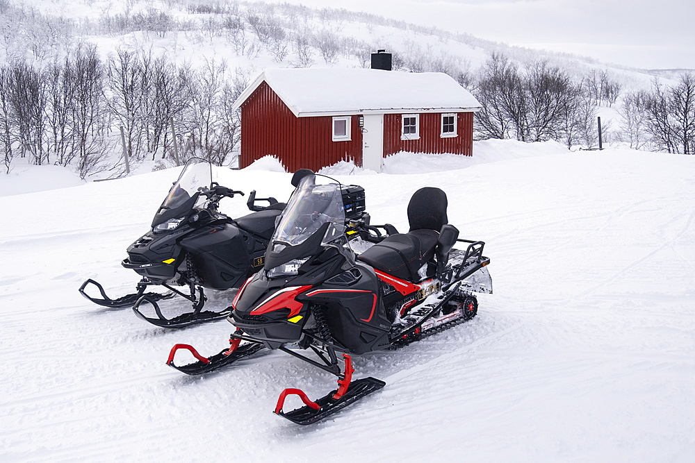 Snowmobiles outside a traditional Sami Cabin (Hytte) in winter, near Lake Eoalbmejavri, Finnmark Plateau, Troms og Finnmark, Arctic Circle, Norway, Scandinavia, Europe