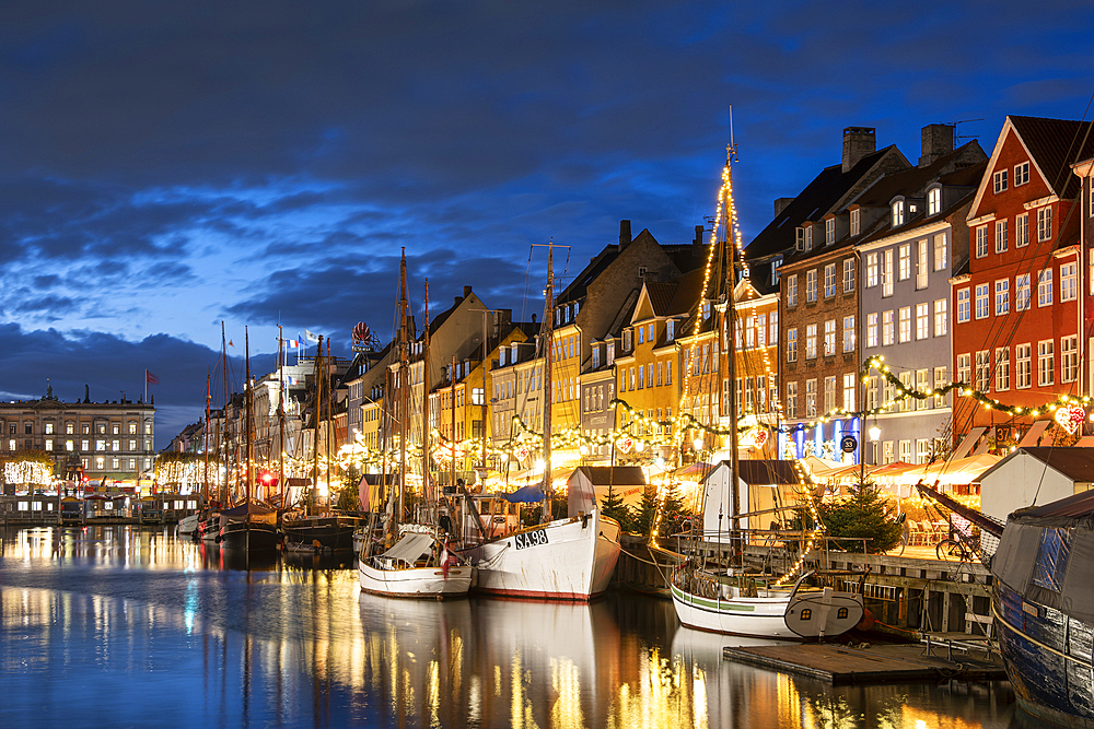 Colourful buildings and tall masted boats on the waterfront at Nyhavn at night, Nyhavn Canal, Nyhavn, Copenhagen, Denmark, Europe