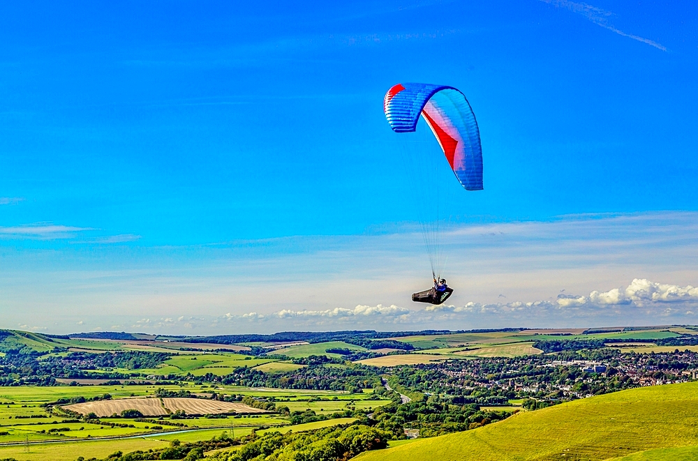 Paragliders at Mount Caburn, flying over the County town of Lewes, East Sussex, England, United Kingdom, Europe