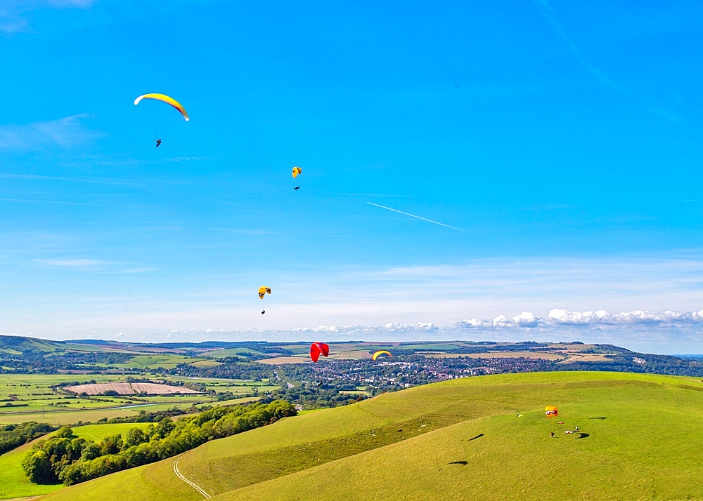 Paragliders at Mount Caburn, flying over the County town of Lewes, East Sussex, England, United Kingdom, Europe