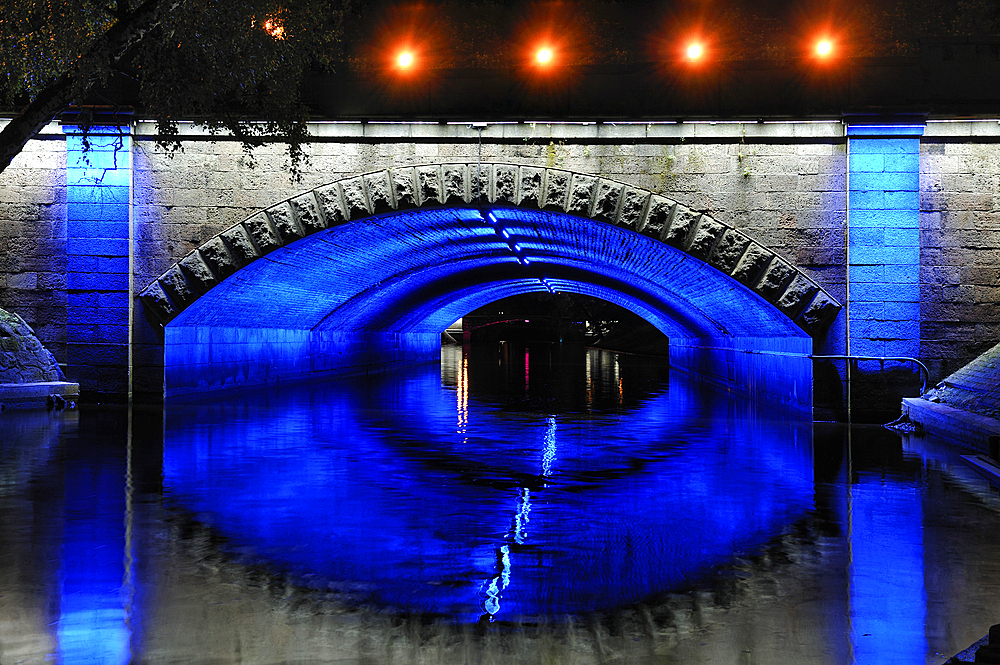 Floodlit Brividas bridge over the Canal surrounding the Old Town of Riga, Latvia, Baltic region, Europe