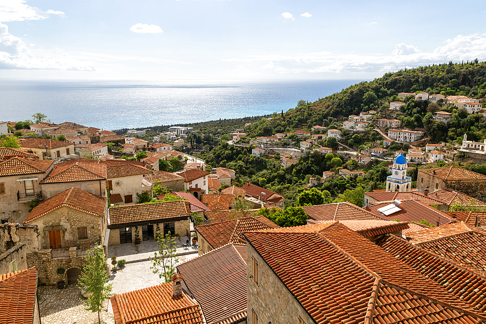 View to Ionian Sea over houses and rooftops with Greek Orthodox Church of Saint Spyridon, village of Dhermi, Albania, Europe