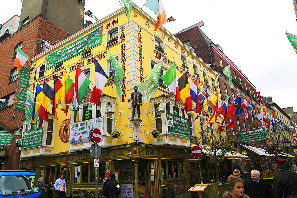 Flags outside colourful yellow Oliver St. John Gogarty pub in Temple Bar area, Dublin city centre, Republic of Ireland, Europe