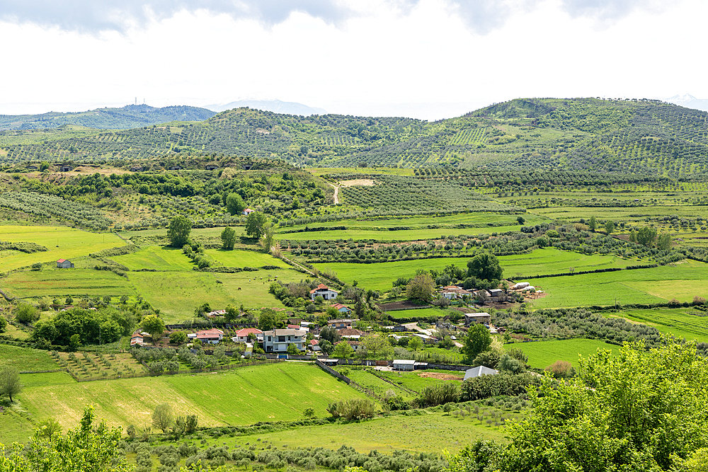 View south east from Apollonia over fields, countryside, hills, village of Kryegjate, Fier County, Albania, Europe