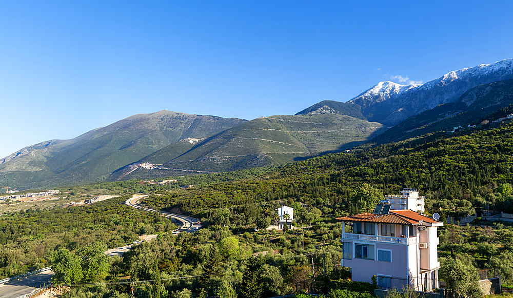 Snow capped peak of Mount Cika and mountain road over Llogara Pass, Palase, near Dhermi, Albania, Europe