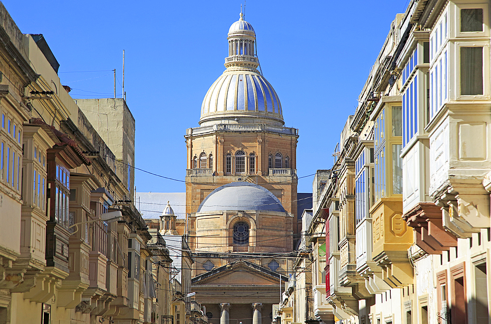 Traditional houses with balconies and dome of Paola Parish Church, Tarxien town, near Valletta, Malta, Mediterranean, Europe