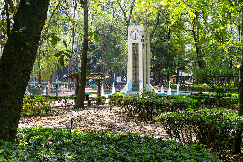 Clock tower, trees and water fountains in Parque Mexico, Colonia Hipodromo, La Condesa neighbourhood, Mexico City, Mexico, North America