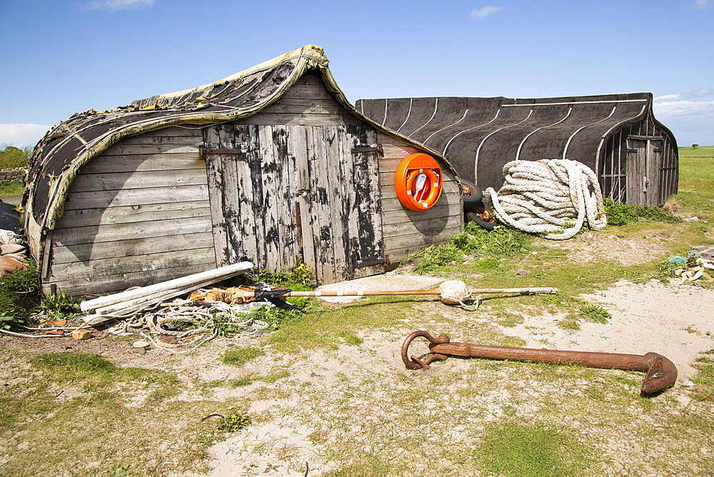 Upturned boats used as storage shed, Holy Island, Lindisfarne, Northumberland, England, UK