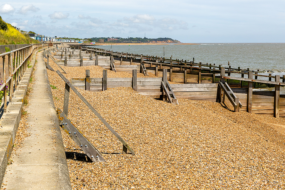 Wooden beach groynes to manage longshore drift, Felixstowe, Suffolk, England, UK view to Bawdsey Manor