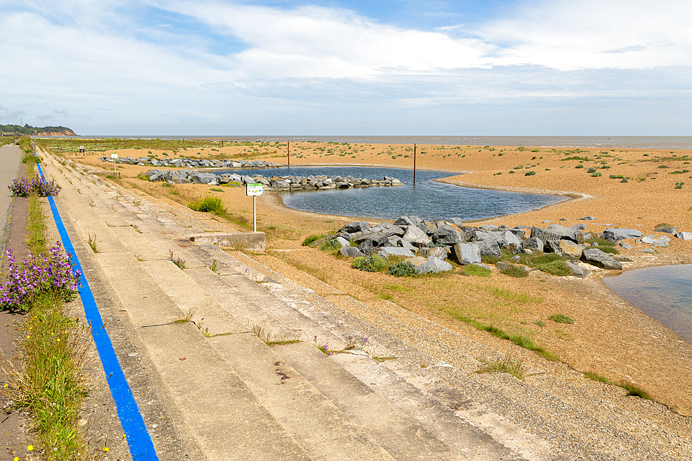 Shingle beach and lagoons in front of coastal defences near Felixstowe Ferry, Suffolk, England, UK