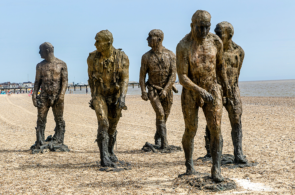 'Walking Men' artwork bronze sculptures by Laurence Edwards, South Beach, Lowestoft, Suffolk,England, UK July 2024