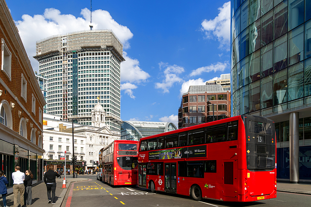 Red double-decker buses in street by Victoria palace theatre, Victoria, Westminster, London, England, UK