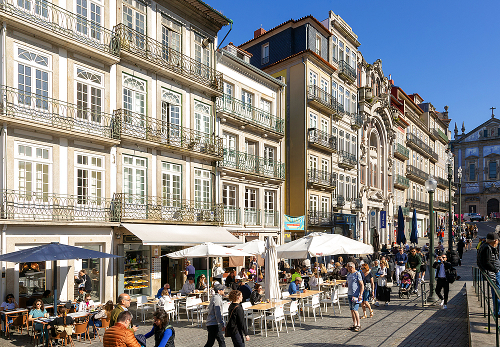 People sitting at cafe tables outside historic buildings, Praça de Almeida Garrett, Rua das Flores, Porto, Portugal, Europe