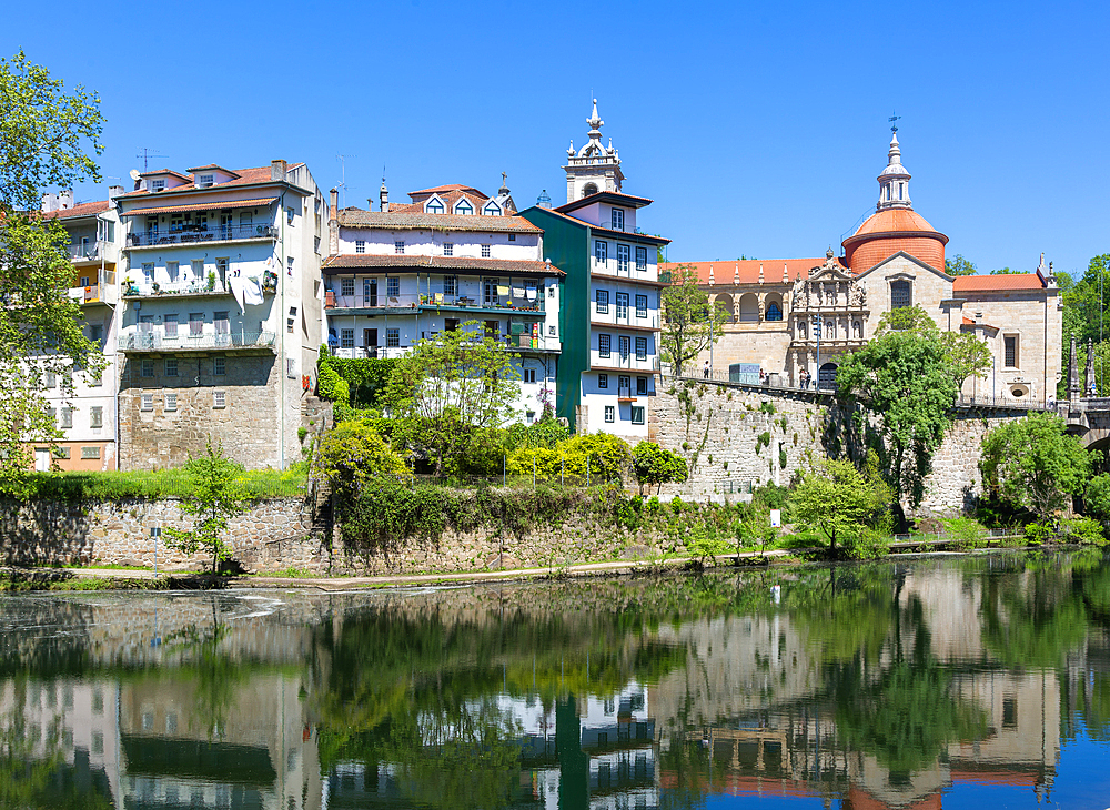Historic buildings reflected in water of River Tamega, Amarante, Tâmega e Sousa, Portugal, Europe