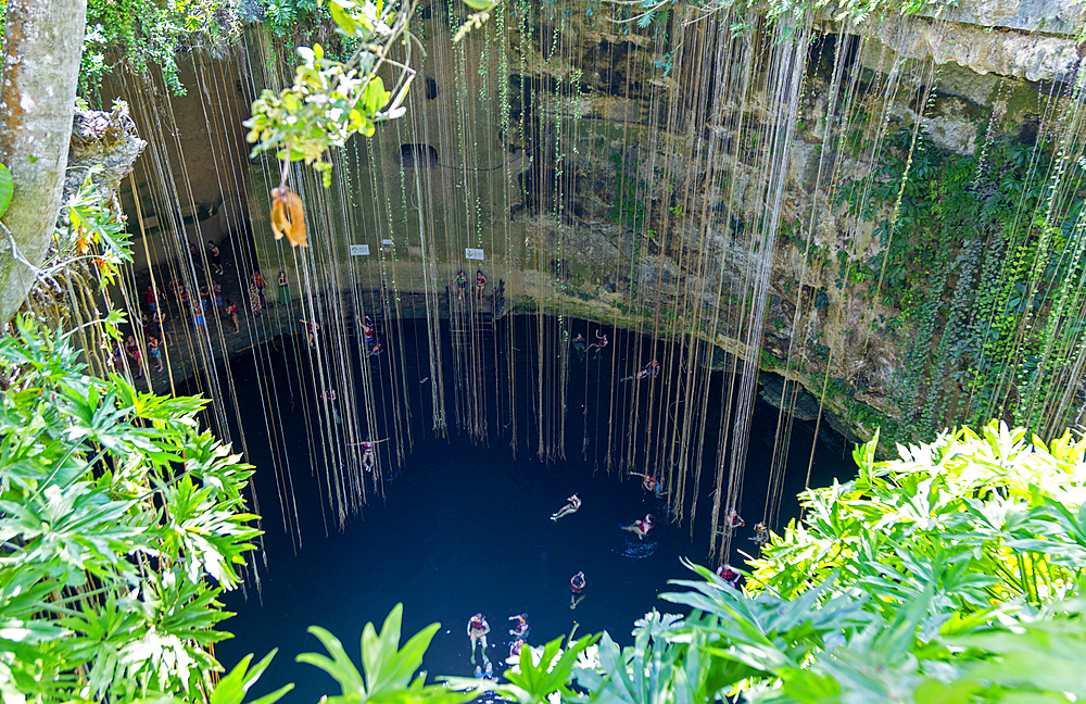 People swimming in limestone sinkhole pool, Cenote Ik kil, Piste, Yucatan, Mexico, North America