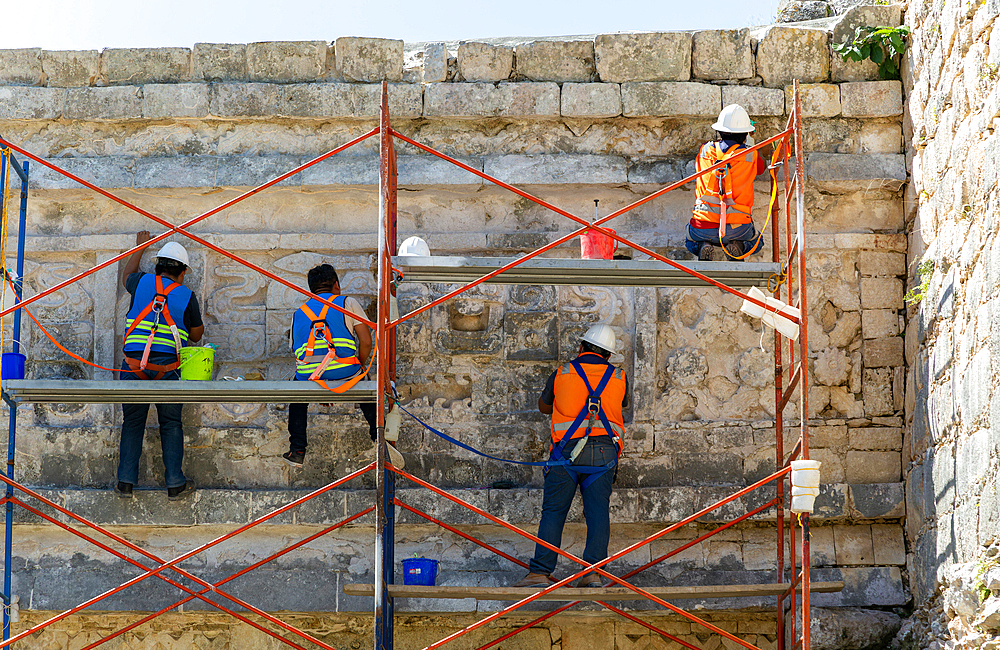 Workers maintaining stonework at The Nunnery (Edificio de las Monjas), Mayan ruins, Chichen Itza, UNESCO World Heritage Site, Yucatan, Mexico, North America