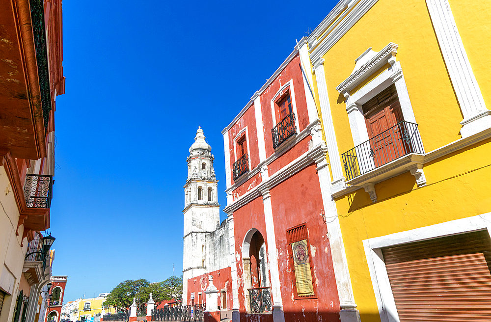 Row of colourful Spanish colonial buildings, with view to Cathedral Church, Campeche City centre, UNESCO World Heritage Site, Campeche State, Mexico, North America