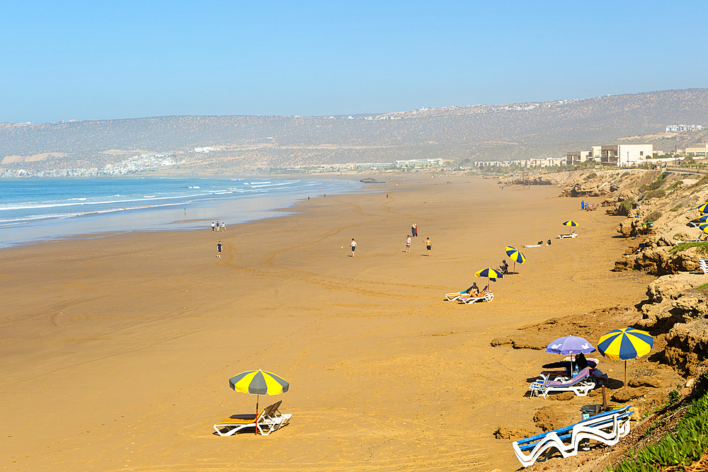 Sandy beach view towards Taghazout, Morocco, North Africa, Africa