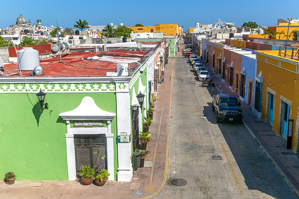 Raised view of street with cars parked and colourful Spanish colonial buildings, Campeche city centre, Campeche State, Mexico, North America