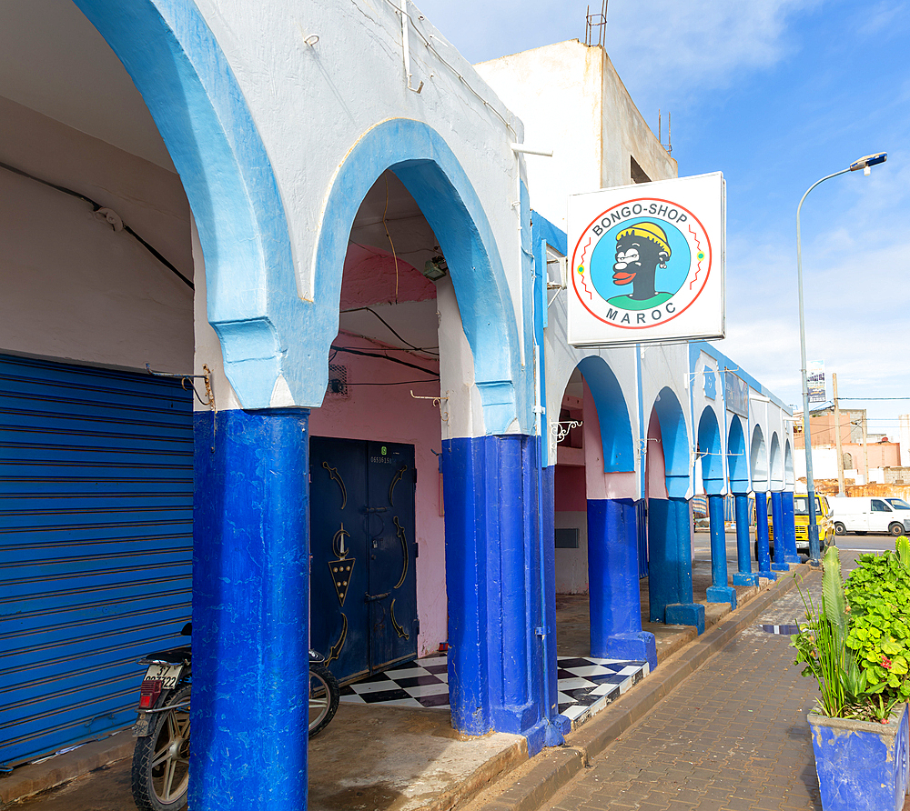 Historic buildings shops and hotel in arcaded shopping street in town centre, Mirleft, southern Morocco, North Africa, Africa