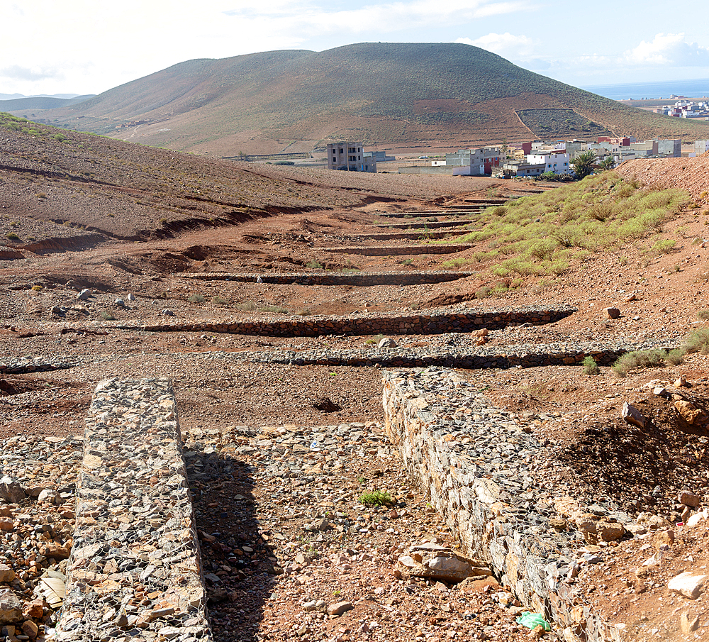 Check dams crossing valley to control risk of flash flooding down steep hillside, Mirleft, Morocco, North Africa, Africa