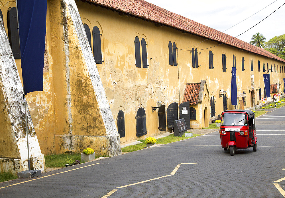 Motorised rickshaw by fort walls inside the historic town of Galle, UNESCO World Heritage Site, Sri Lanka, Asia