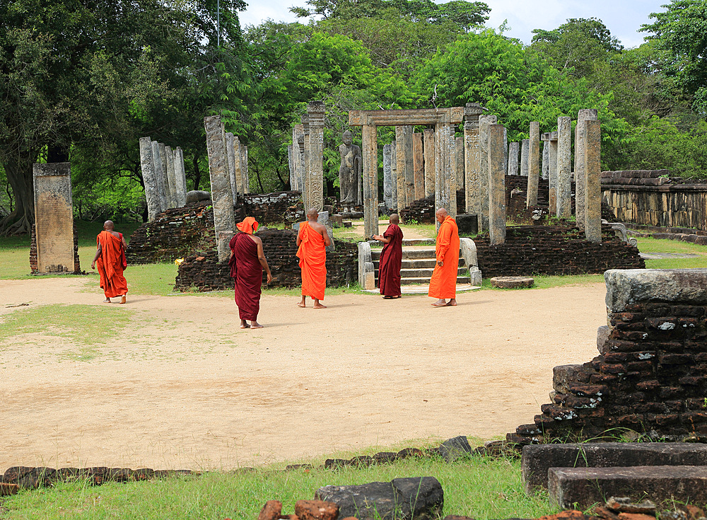 Buddhist monks visiting the Atadage building in The Quadrangle, ancient city of Polonnaruwa, UNESCO World Heritage Site, Sri Lanka, Asia