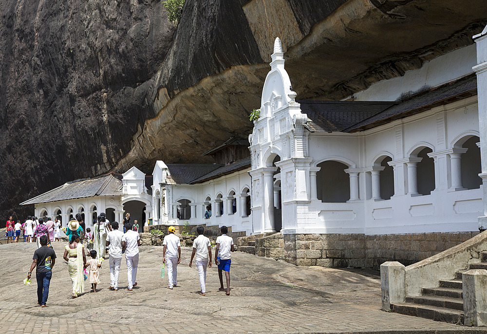 People at Dambulla cave Buddhist temple complex, UNESCO World Heritage Site, Sri Lanka, Asia