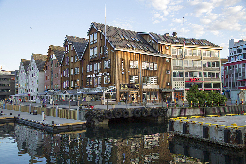 Historic wooden buildings with bars and restaurants along harbour waterside, Tromso, Norway, Scandinavia, Europe