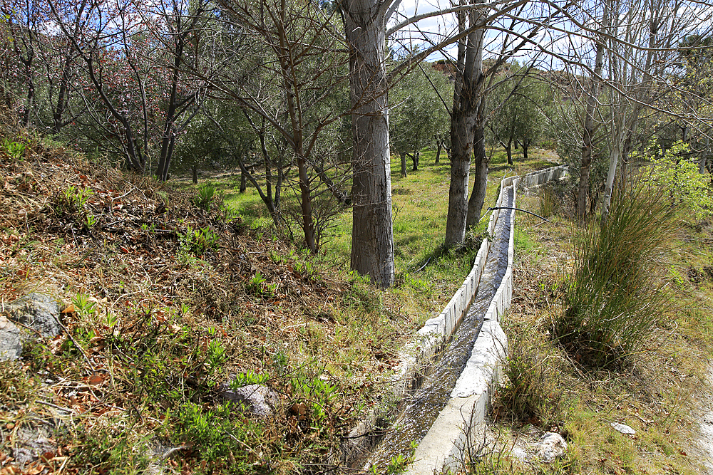 Irrigation channel carrying water, Huebro, Sierra Alhamilla mountains, Nijar, Almeria, Andalusia, Spain, Europe