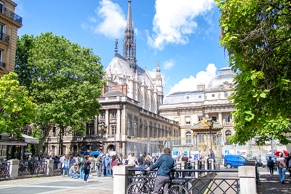 Sunny day in a bustling European city square with historical architecture and pedestrians, Paris, France, Europe