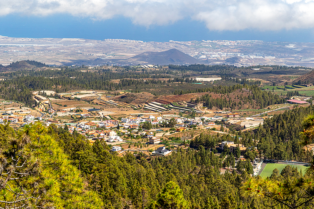 Scenic view of a valley with small buildings, surrounded by lush greenery and mountains under a cloudy sky, Tenerife, Canary Islands, Spain, Atlantic, Europe