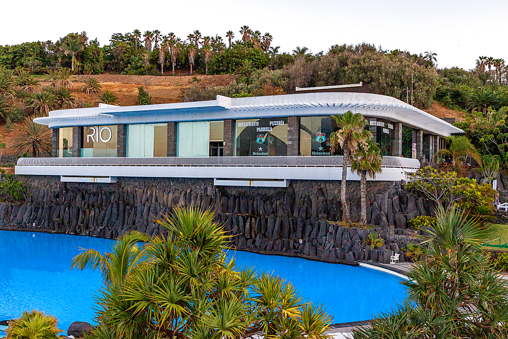 Modern luxury house with large windows and a swimming pool, surrounded by tropical vegetation on a hillside in Santa Cruz de Tenerife, Canary Islands, Spain, Atlantic, Europe