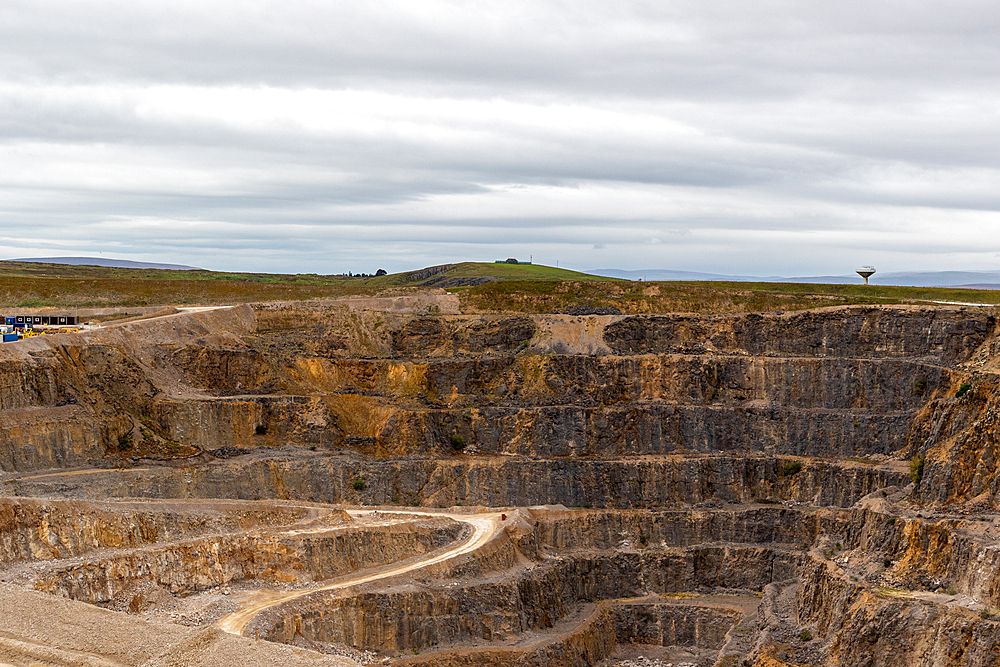 Expansive open-pit mine with winding roads under a cloudy sky, North Yorkshire, England, United Kingdom, Europe