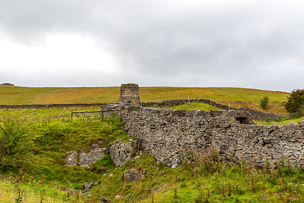 Rustic stone ruins in a green countryside under a cloudy sky, North Yorkshire, England, United Kingdom, Europe