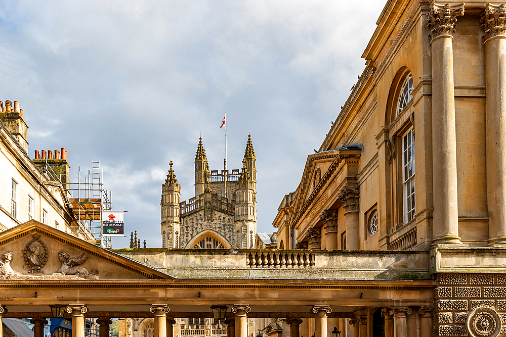 Elegant historical architecture with ornate facades under a cloudy sky in Bath, Somerset, England, United Kingdom, Europe