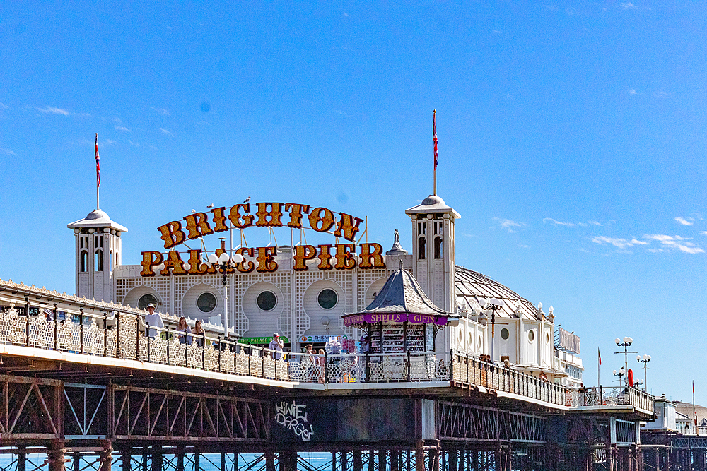 Brighton Palace Pier under clear blue skies, iconic British seaside attraction with amusement arcade, Brighton, Sussex, England, United Kingdom, Europe