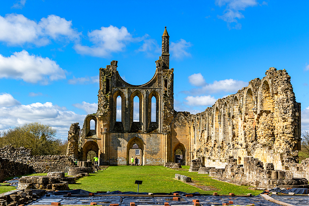 Ancient ruins of a Gothic abbey under blue sky with clouds at Byland Abbey, North Yorkshire, England, United Kingdom, Europe