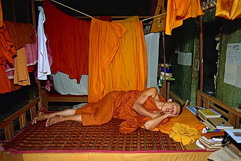 A sleeping monk beneath saffron robes in Cambodia, Indochina, Southeast Asia, Asia